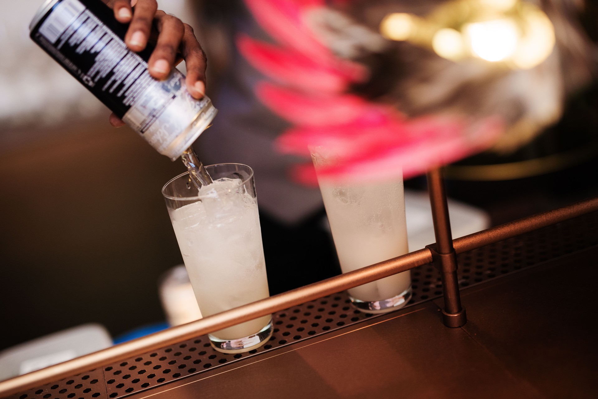 Bartender mixing Drinks with Can Drinks Tonic Water