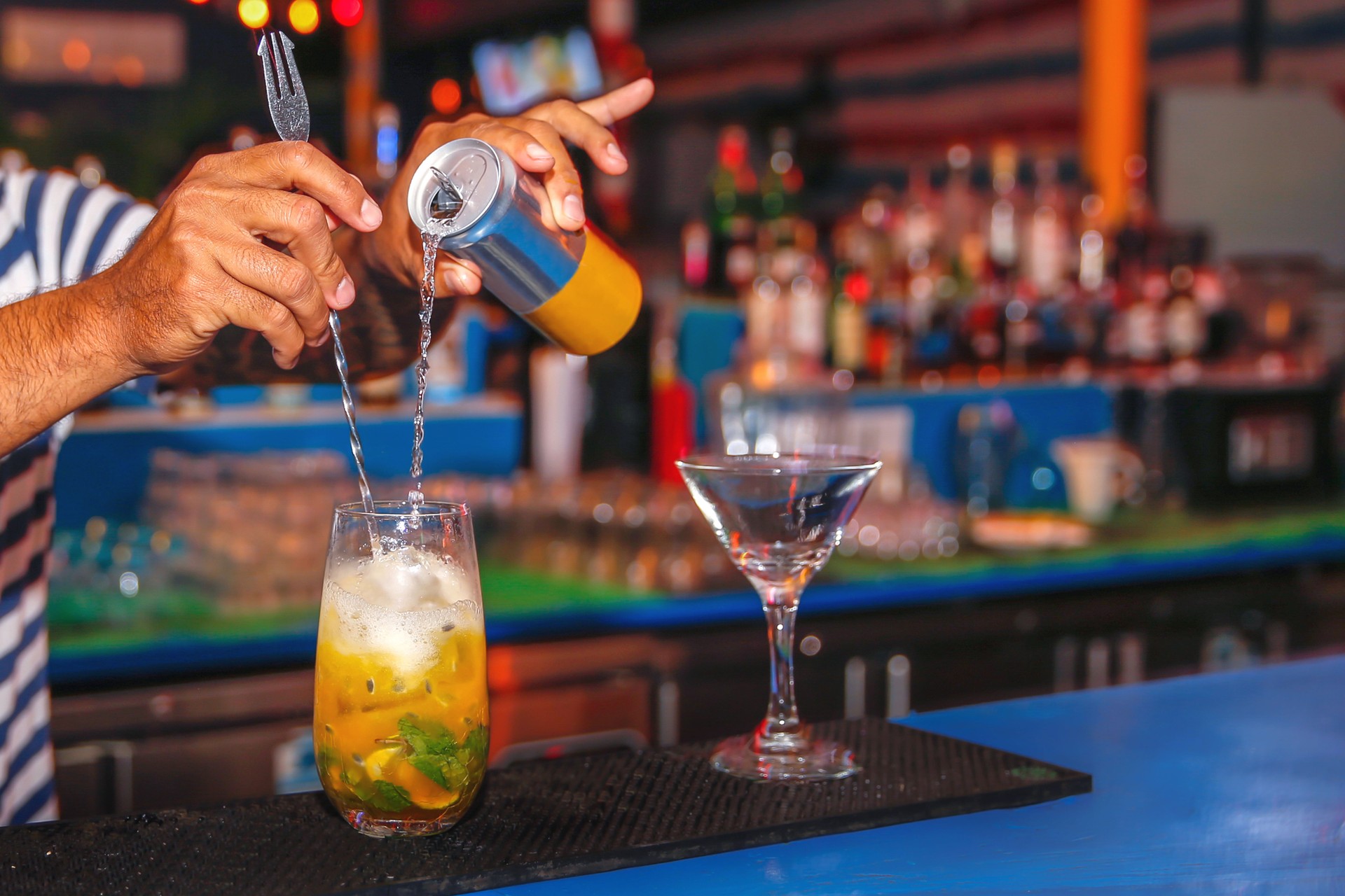 Barman making summer cocktail